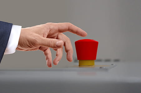 person pressing red button