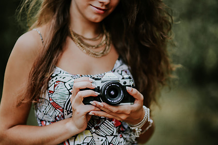 Woman in a dress with a camera