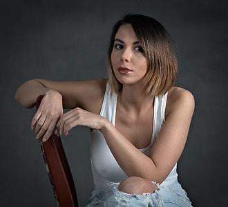 sitting woman wearing white tank top
