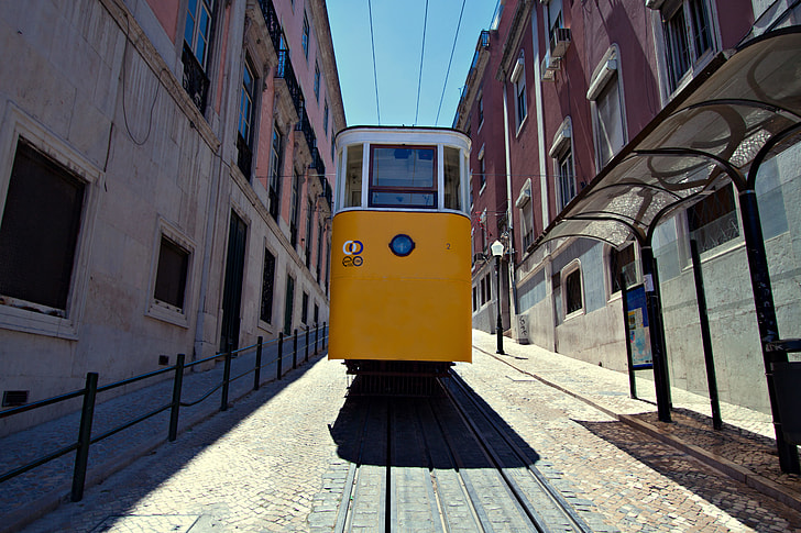 Wide angle shot of a classic yellow tram in the centre of Lisbon, Portugal