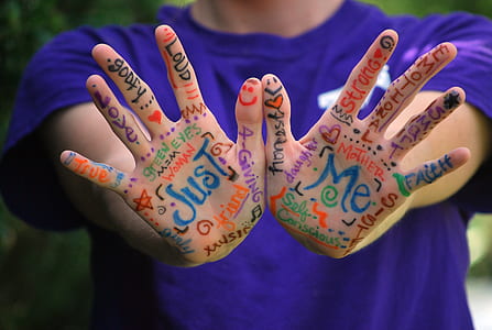person wearing purple crew-neck t-shirt with hand art