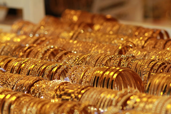 photography of gold-colored bracelet lot