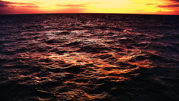 time lapse photo of body of water under the sunrise
