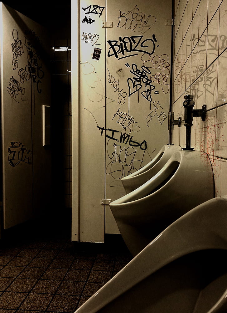 typographic vandals on bathroom walls