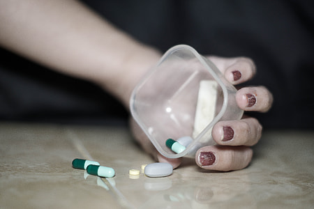 person holding cup of pills graphic wallpaper