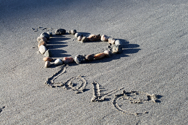 love text on gray sand