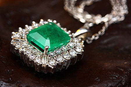 silver-colored green and clear gemstone encrusted pendant necklace