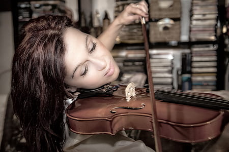 woman playing a brown violin