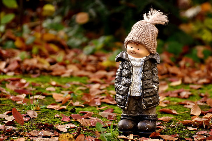 boy wearing black bubble jacket and knit cap figurine