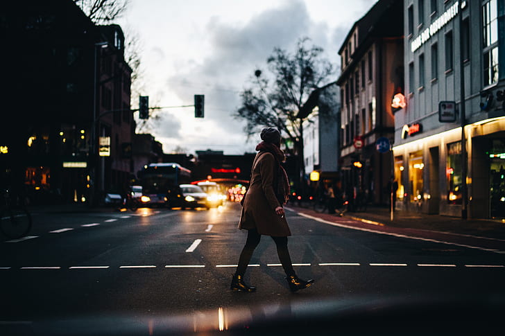 person walking on street during nighttime