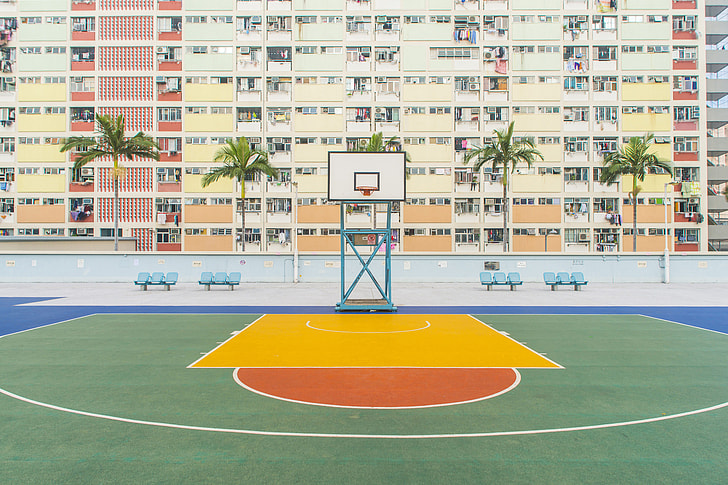 basketball field beside concrete building during daytime
