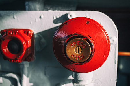 Close-up shot of a big red button, this image was captured on an old warship in Chatham Dockyard in Kent, England