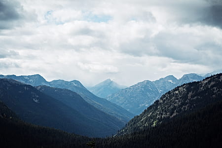 photography of mountains during cloudy skies