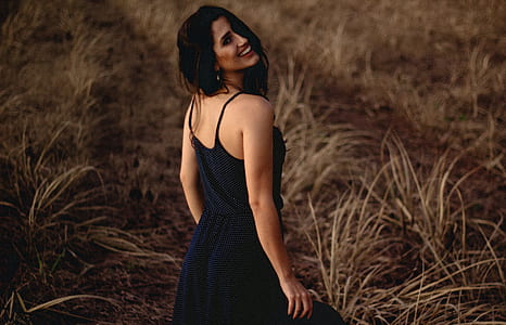 shallow focus photograph of woman in black spaghetti strap dress