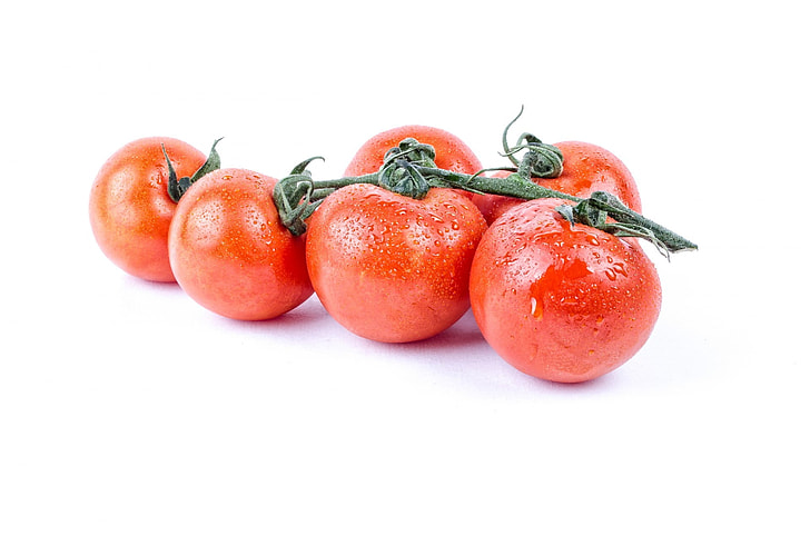 five red cherry tomatoes