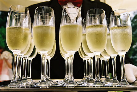 filled clear glass champagne flutes