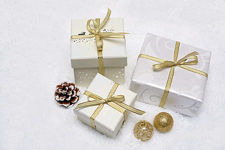 three white and brown gift boxes