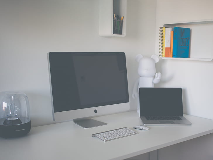 silver iMac, Apple Wireless Keyboard, and MacBook Pro on desk