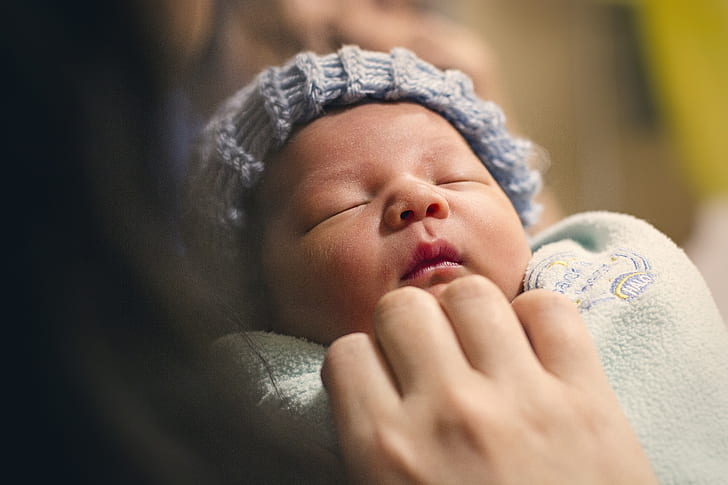 shallow focus photography of newborn baby