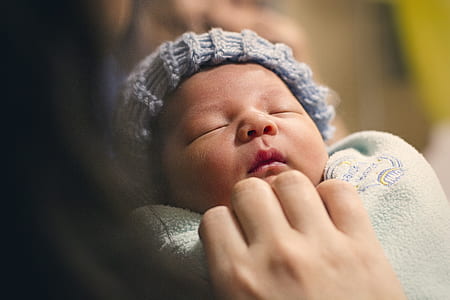 shallow focus photography of newborn baby