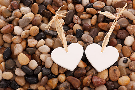 two white hearts on pebbles
