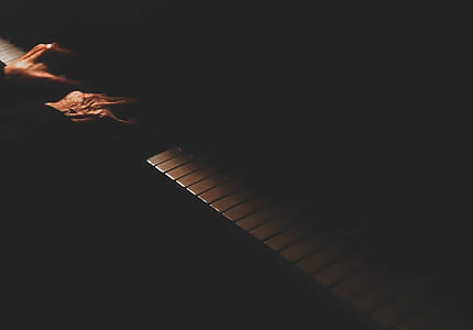 photo of a person playing piano