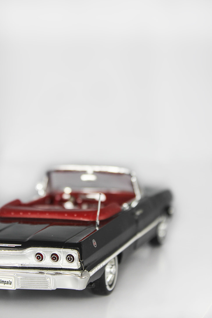 shallow focus photography of black convertible die-cast model