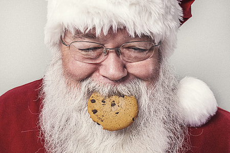 Santa Claus with cookie on his mouth