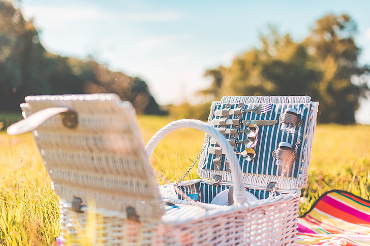 Royalty-Free photo: White Picnic Basket with Service on a Meadow | PickPik