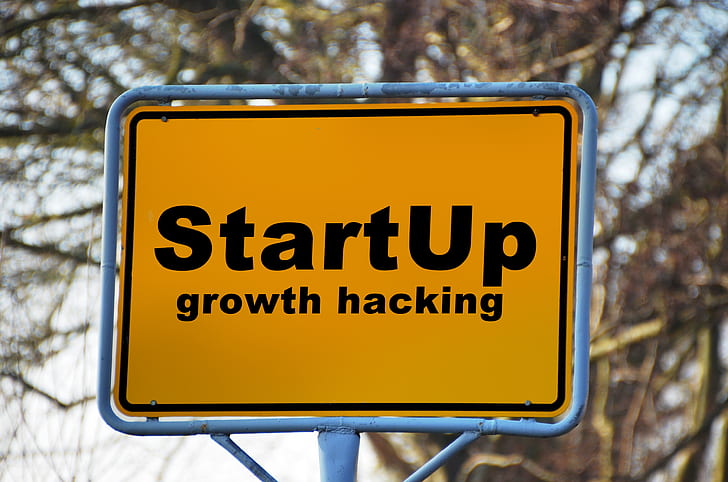 black and yellow start up growth hacking signage