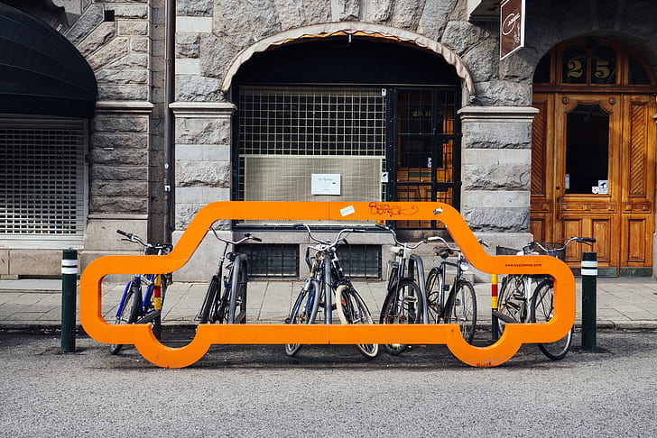 bicycles parked near gray concrete building