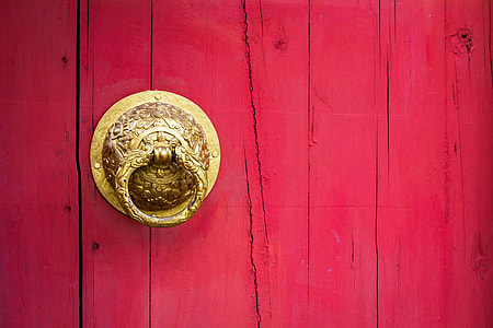 round gold-colored door knocker