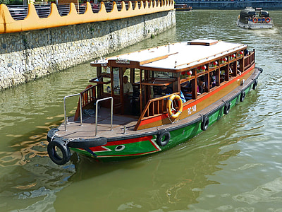 photo of green and brown barge during daytime