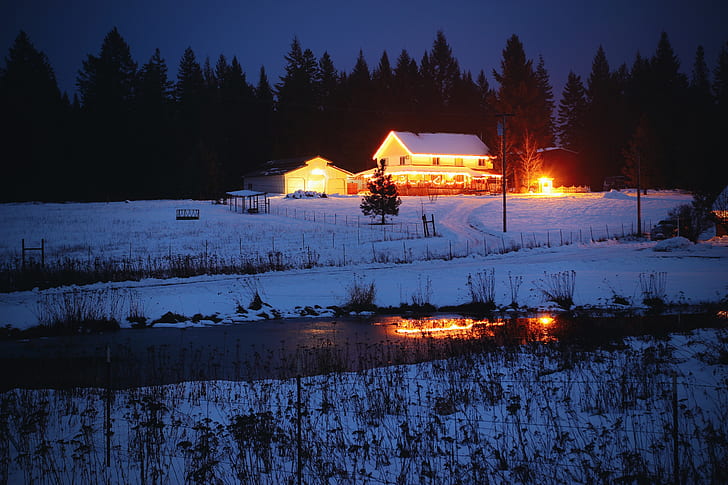 snow covered house under nighttime sky