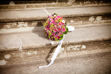 pink rose flowers and green chrysanthemums bouquet on brown concrete stair