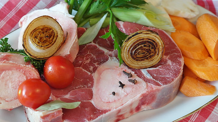 raw meat with vegetables on plate