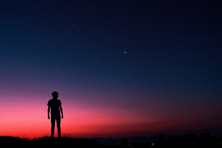 Silhouette of man standing on summer night