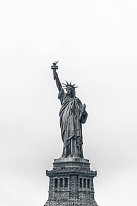 statue of Liberty under white sky photography during daytime