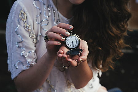 woman holding pocket watch at 5:30