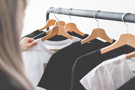 Woman Choosing T-Shirts During Clothing Shopping at Apparel Store