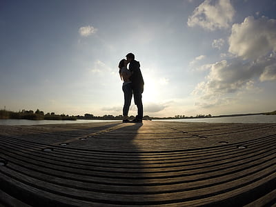 silhouette of kissing man and woman fish-eye photography