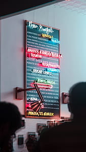 Neon sign on white painted wall