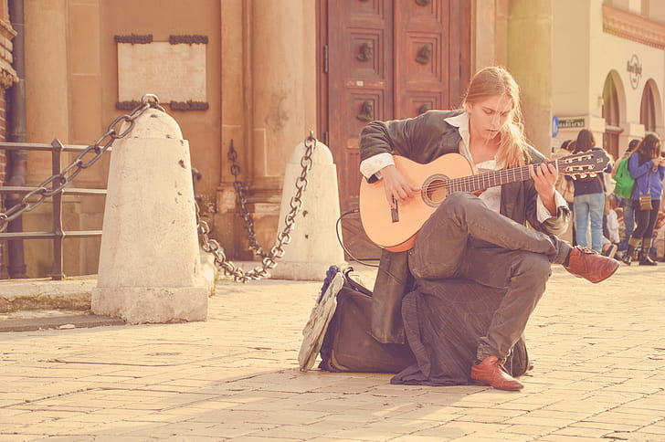 man sitting playing guitar