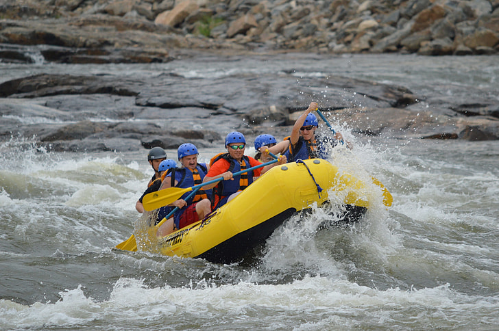 group of people rafting on river