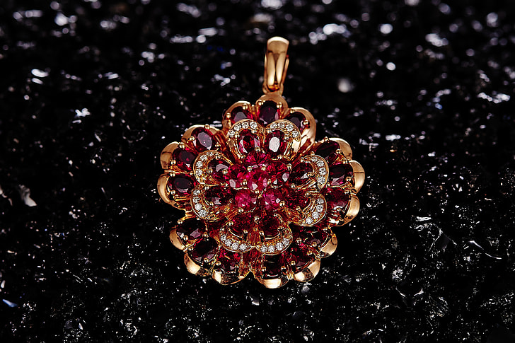 gold-colored red gemstone encrusted pendant