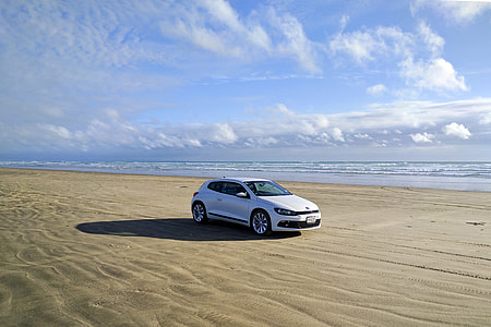White car on sandy beach