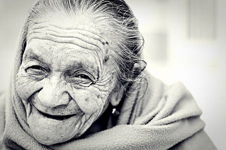 greyscale photo of woman smiling