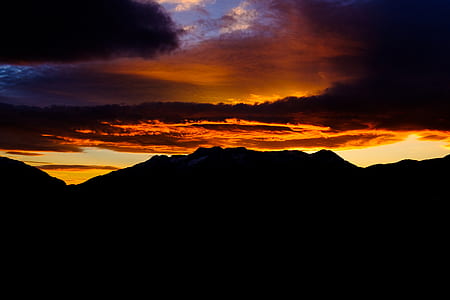 silhouette of mountain during sunset photography
