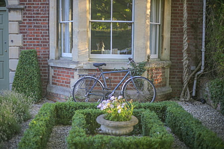 Grey Mountain Bike Leaning on Brown Wall Brick in Garden
