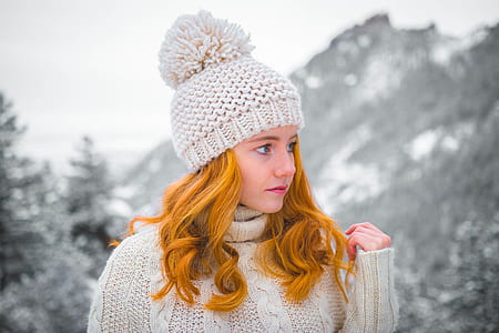 woman wearing white knitted bobble hat